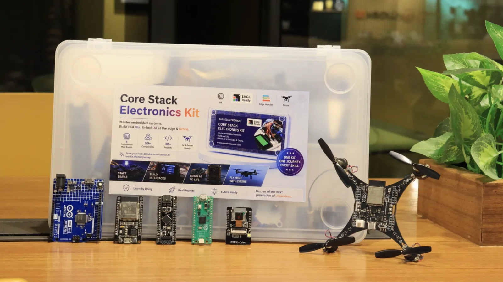 The five CoreStack boards and the PCB drone lined up in front of the kit case